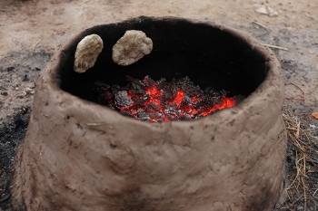 Ancient tanur (earthen oven) baking loaves